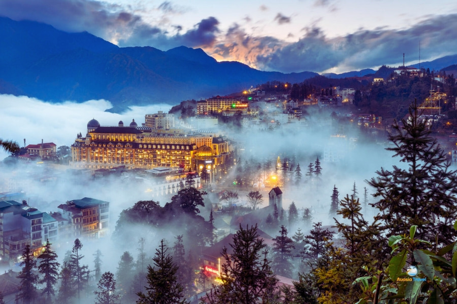 Panoramic view of fog-covered Sapa town surrounded by mountains – Auasia Travel